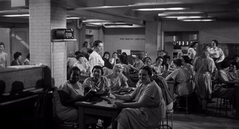 Movie still from “I Want to Live!” (1958), directed by Robert Wise – Black and white photograph of people sitting at a table; Wide shot, High angle