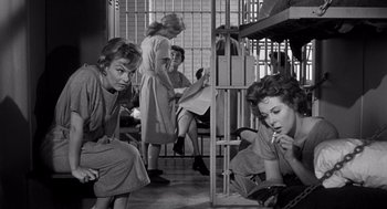 Movie still from “I Want to Live!” (1958), directed by Robert Wise – A black and white photo of a group of women sitting on the floor; Medium shot, Low angle