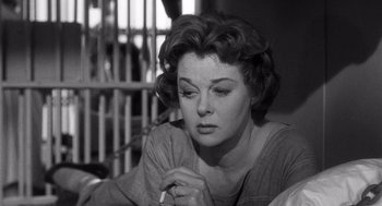 Movie still from “I Want to Live!” (1958), directed by Robert Wise – An old photo of a woman with a cigarette in her mouth; Close Up shot, Low angle