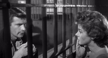 Movie still from “I Want to Live!” (1958), directed by Robert Wise – A woman sitting next to a man in a jail cell; Close Up shot, Over the shoulder angle