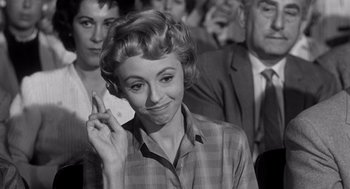 Movie still from “I Want to Live!” (1958), directed by Robert Wise – An old black and white photo of a woman on a cell phone; Close Up shot, Over the shoulder angle