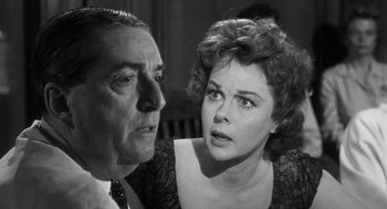 Movie still from “I Want to Live!” (1958), directed by Robert Wise – An older man and a younger woman looking at each other; Close Up shot, Over the shoulder angle