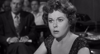 Movie still from “I Want to Live!” (1958), directed by Robert Wise – An old photo of a woman in a black dress; Close Up shot, Over the shoulder angle