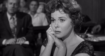 Movie still from “I Want to Live!” (1958), directed by Robert Wise – An old black and white photo of a woman looking sad; Close Up shot, Over the shoulder angle