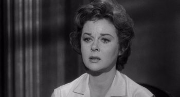 Movie still from “I Want to Live!” (1958), directed by Robert Wise – An old photo of an older woman looking at the camera; Close Up shot, Over the shoulder angle