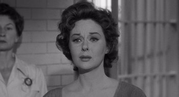 Movie still from “I Want to Live!” (1958), directed by Robert Wise – An old photo of a woman in a dress looking sad; Close Up shot, Over the shoulder angle