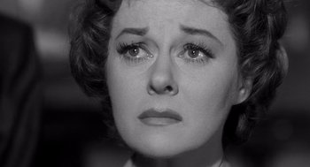 Movie still from “I Want to Live!” (1958), directed by Robert Wise – An old photo of a woman looking sad; Close Up shot, Low angle