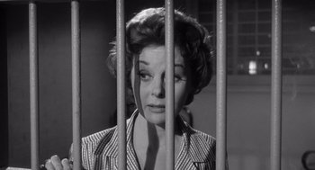 Movie still from “I Want to Live!” (1958), directed by Robert Wise – An old photo of a woman behind a fence; Close Up shot, Low angle
