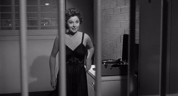 Movie still from “I Want to Live!” (1958), directed by Robert Wise – A black and white photo of a woman standing in a jail cell; Medium shot, Low angle