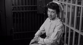 Movie still from “I Want to Live!” (1958), directed by Robert Wise – An old photo of a woman sitting in a chair; Medium shot, Low angle