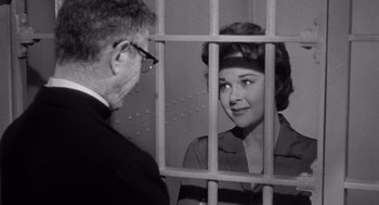 Movie still from “I Want to Live!” (1958), directed by Robert Wise – An older man and a woman in a jail cell; Medium shot, Low angle