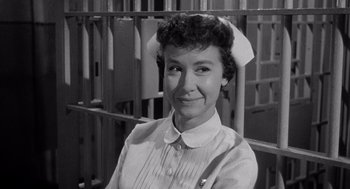 Movie still from “I Want to Live!” (1958), directed by Robert Wise – An old photo of a woman in front of a jail cell; Close Up shot, High angle