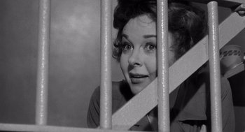 Movie still from “I Want to Live!” (1958), directed by Robert Wise – A black - and - white photo of a woman behind bars; Close Up shot, Low angle