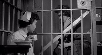Movie still from “I Want to Live!” (1958), directed by Robert Wise – Two women are sitting in a jail cell drinking coffee; Medium shot, Low angle