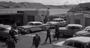 Movie still from “I Want to Live!” (1958), directed by Robert Wise – A black and white photo of men walking down a street; Extreme Wide shot, High angle