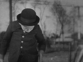 Movie still from “I Was Born, But...” (1932), directed by Yasujirô Ozu – A man wearing a top hat and a jacket; Medium shot, High angle