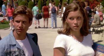 Movie still from “I'll Be Home for Christmas” (1998), directed by Arlene Sanford – Two young people standing next to each other on a sidewalk; Medium shot, Over the shoulder angle