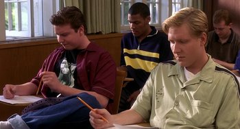 Movie still from “I'll Be Home for Christmas” (1998), directed by Arlene Sanford – A group of men sitting at a table writing on a piece of paper; Medium shot, High angle