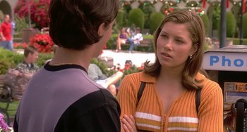 Movie still from “I'll Be Home for Christmas” (1998), directed by Arlene Sanford – A young woman talking to a young man in an outdoor setting; Medium shot, Over the shoulder angle
