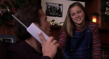 Movie still from “I'll Be Home for Christmas” (1998), directed by Arlene Sanford – A man and a woman are talking on a phone; Close Up shot, High angle