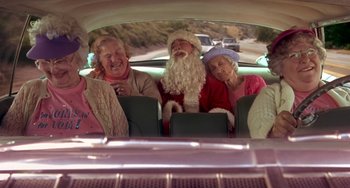 Movie still from “I'll Be Home for Christmas” (1998), directed by Arlene Sanford – A group of people sitting in the back of a car; Wide shot, High angle