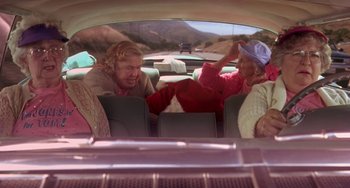 Movie still from “I'll Be Home for Christmas” (1998), directed by Arlene Sanford – Two older women sitting in the back seat of a car; Medium shot, High angle