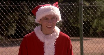 Movie still from “I'll Be Home for Christmas” (1998), directed by Arlene Sanford – A man in a santa clause outfit smiling for the camera; Close Up shot, Low angle