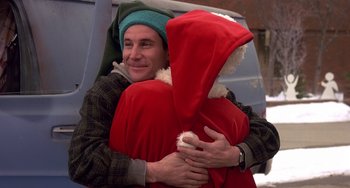 Movie still from “I'll Be Home for Christmas” (1998), directed by Arlene Sanford – A man holding a santa clause in his arms and smiling; Close Up shot, Low angle