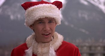 Movie still from “I'll Be Home for Christmas” (1998), directed by Arlene Sanford – A man wearing a santa clause outfit and a red hat; Close Up shot, Over the shoulder angle