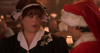 Movie still from “I'll Be Home for Christmas” (1998), directed by Arlene Sanford – A woman wearing a christmas hat and a dress; Close Up shot, Over the shoulder angle