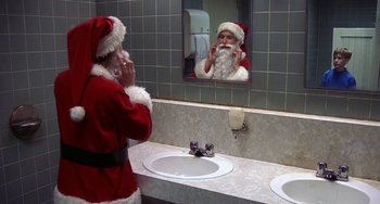Movie still from “I'll Be Home for Christmas” (1998), directed by Arlene Sanford – A man dressed as santa in a bathroom mirror; Close Up shot, Over the shoulder angle