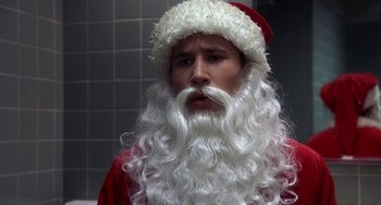 Movie still from “I'll Be Home for Christmas” (1998), directed by Arlene Sanford – A person wearing a santa claus costume; Close Up shot, Low angle