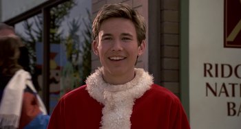 Movie still from “I'll Be Home for Christmas” (1998), directed by Arlene Sanford – A man in a santa clause outfit smiling for the camera; Close Up shot, Low angle