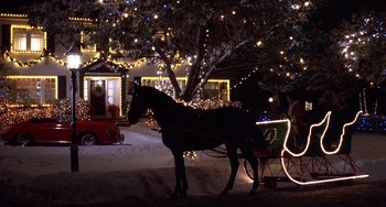 Movie still from “I'll Be Home for Christmas” (1998), directed by Arlene Sanford – A horse drawn carriage in the snow at night; Extreme Wide shot, High angle