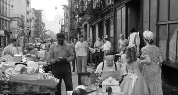 Movie still from “I'll Cry Tomorrow” (1955), directed by Daniel Mann – A black - and - white photo of people on a street; Wide shot, High angle