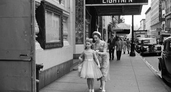 Movie still from “I'll Cry Tomorrow” (1955), directed by Daniel Mann – An old photo of a woman and a little girl walking down the street; Wide shot, Low angle