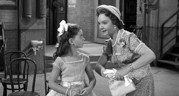 Movie still from “I'll Cry Tomorrow” (1955), directed by Daniel Mann – An old photo of a woman talking to a young girl; Medium shot, Over the shoulder angle