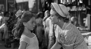 Movie still from “I'll Cry Tomorrow” (1955), directed by Daniel Mann – A woman talking to a young girl on the street; Medium shot, Over the shoulder angle
