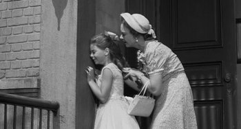 Movie still from “I'll Cry Tomorrow” (1955), directed by Daniel Mann – An older woman and a young girl standing next to each other; Medium shot, Over the shoulder angle
