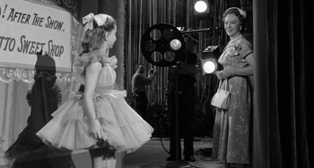 Movie still from “I'll Cry Tomorrow” (1955), directed by Daniel Mann – A little girl and a woman are in a movie studio; Medium shot, Over the shoulder angle