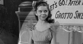 Movie still from “I'll Cry Tomorrow” (1955), directed by Daniel Mann – A little girl in a dress standing in front of a building; Close Up shot, High angle