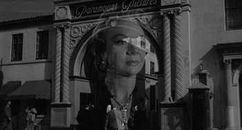 Movie still from “I'll Cry Tomorrow” (1955), directed by Daniel Mann – A black - and - white photo of a woman's face in front of a building; Wide shot, Low angle