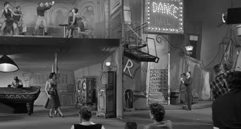 Movie still from “I'll Cry Tomorrow” (1955), directed by Daniel Mann – A black and white photo of a scene in a theater; Wide shot, Low angle