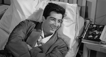 Movie still from “I'll Cry Tomorrow” (1955), directed by Daniel Mann – Black and white photograph of a man smiling in bed; Close Up shot, High angle