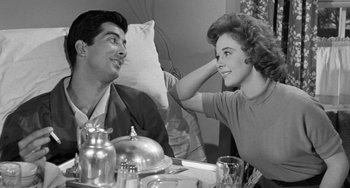 Movie still from “I'll Cry Tomorrow” (1955), directed by Daniel Mann – A man and a woman sitting at a dinner table; Medium shot, Over the shoulder angle