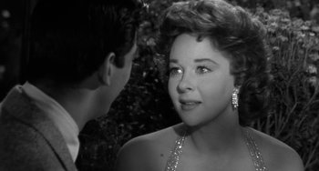 Movie still from “I'll Cry Tomorrow” (1955), directed by Daniel Mann – A young woman in a dress and a man in a suit; Close Up shot, Over the shoulder angle