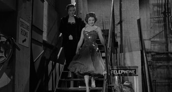Movie still from “I'll Cry Tomorrow” (1955), directed by Daniel Mann – Two women walking down a set of stairs; Medium shot, Low angle