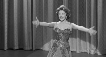 Movie still from “I'll Cry Tomorrow” (1955), directed by Daniel Mann – An old photo of a woman in an evening gown; Medium shot, Low angle