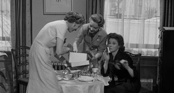 Movie still from “I'll Cry Tomorrow” (1955), directed by Daniel Mann – A group of women standing around a table with food; Medium shot, High angle