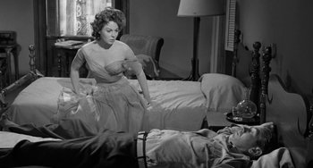 Movie still from “I'll Cry Tomorrow” (1955), directed by Daniel Mann – An old photo of a woman sitting on a bed; Medium shot, Over the shoulder angle